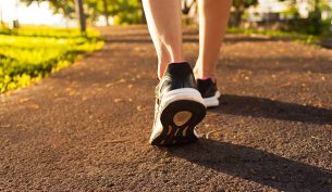 Close up woman walking on a path. Fitness concept.